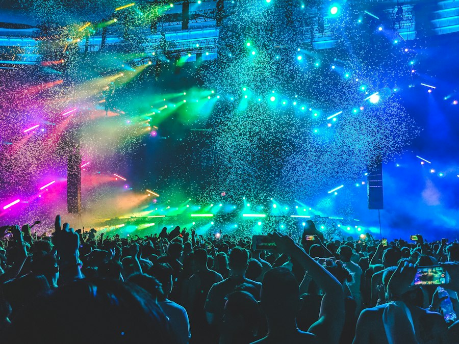 Concert crowd with rainbow lights at queer party